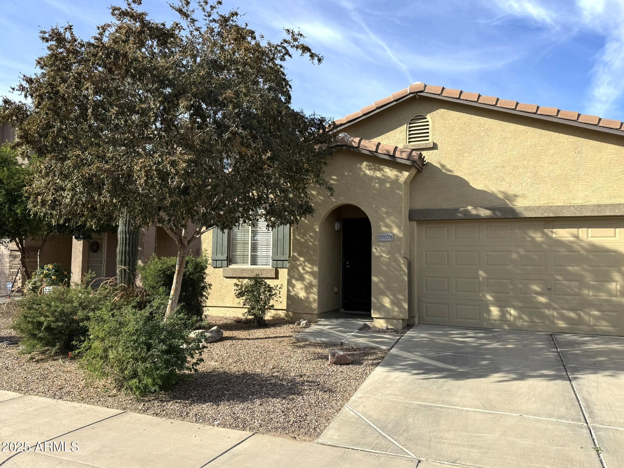 19078 North Lariat Road Maricopa, AZ 85138 - Photo 2 of 30 a front view of a house with a yard