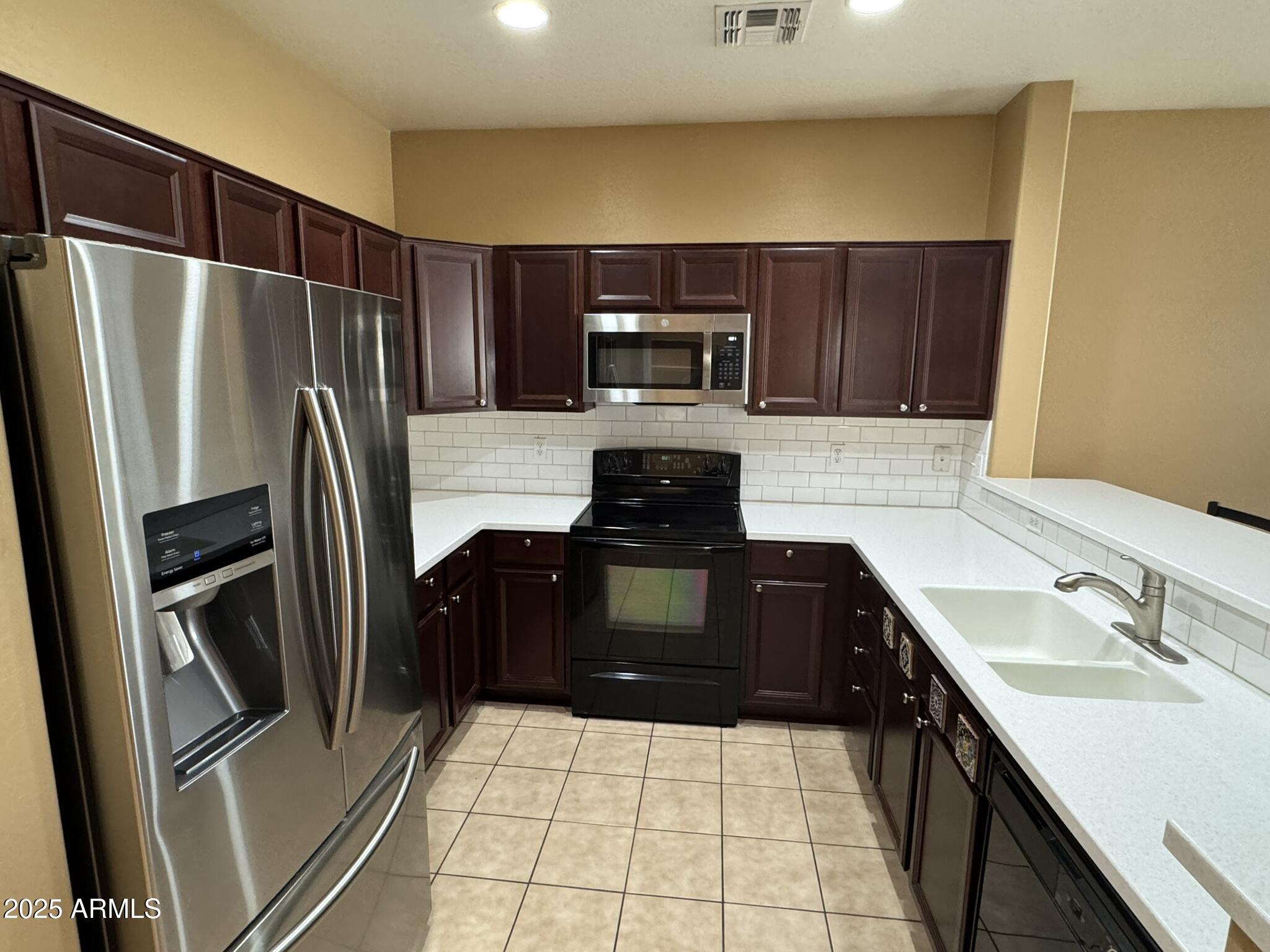 19078 North Lariat Road Maricopa, AZ 85138 - Photo 7 of 30 a kitchen with a refrigerator sink and microwave
