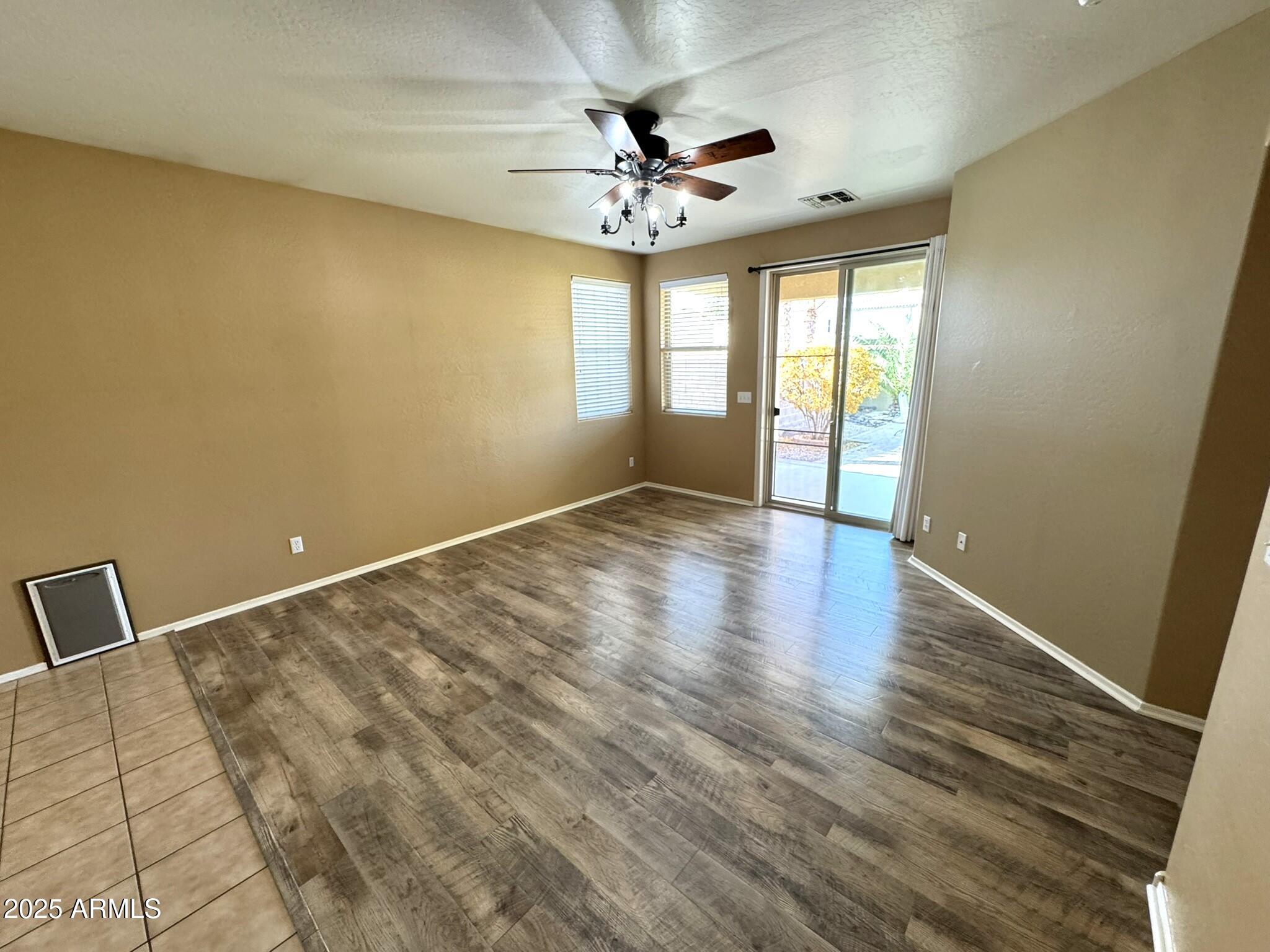 19078 North Lariat Road Maricopa, AZ 85138 - Photo 9 of 30 wooden floor in an empty room with a window