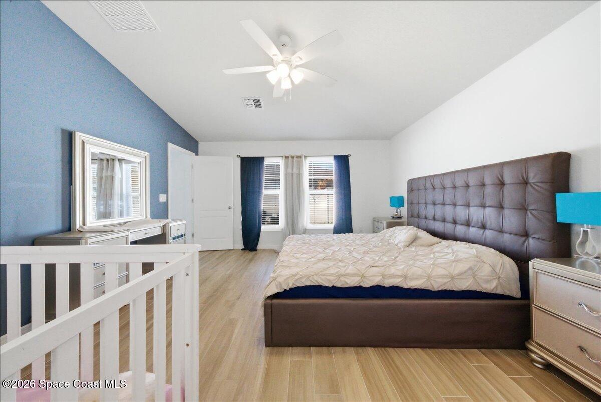 3258 Olivera Way St. Cloud, FL 34772 - Photo 10 of 30 a spacious bedroom with a large bed and a chandelier