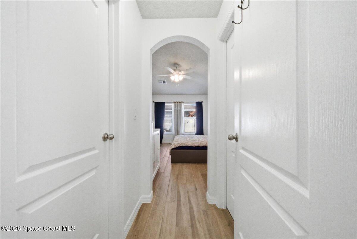 3258 Olivera Way St. Cloud, FL 34772 - Photo 11 of 30 a hallway with a door and a mirror