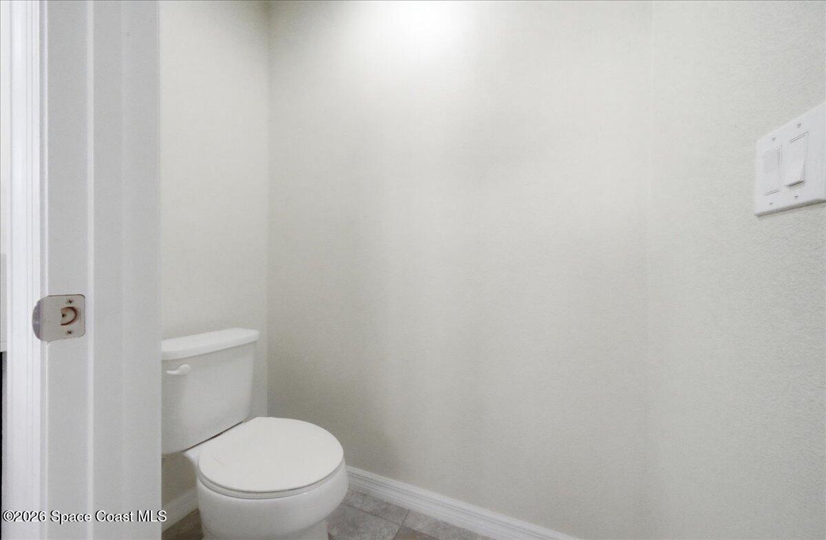 3258 Olivera Way St. Cloud, FL 34772 - Photo 12 of 30 a white toilet sitting next to a white wall