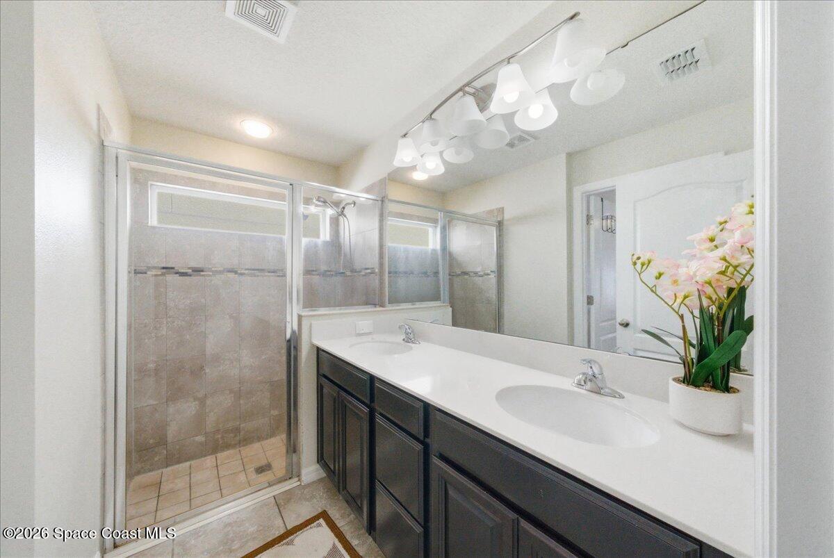 3258 Olivera Way St. Cloud, FL 34772 - Photo 13 of 30 a bathroom with a shower sink and mirror