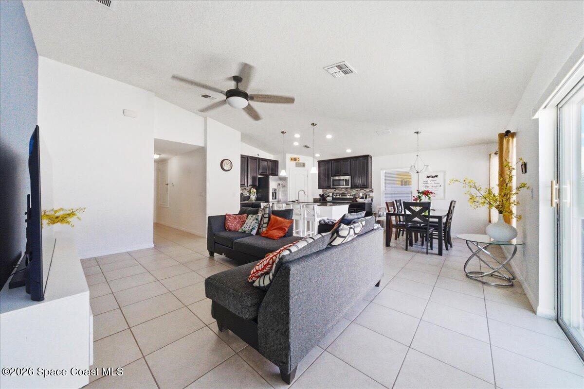 3258 Olivera Way St. Cloud, FL 34772 - Photo 19 of 30 a living room with lots of furniture and kitchen view