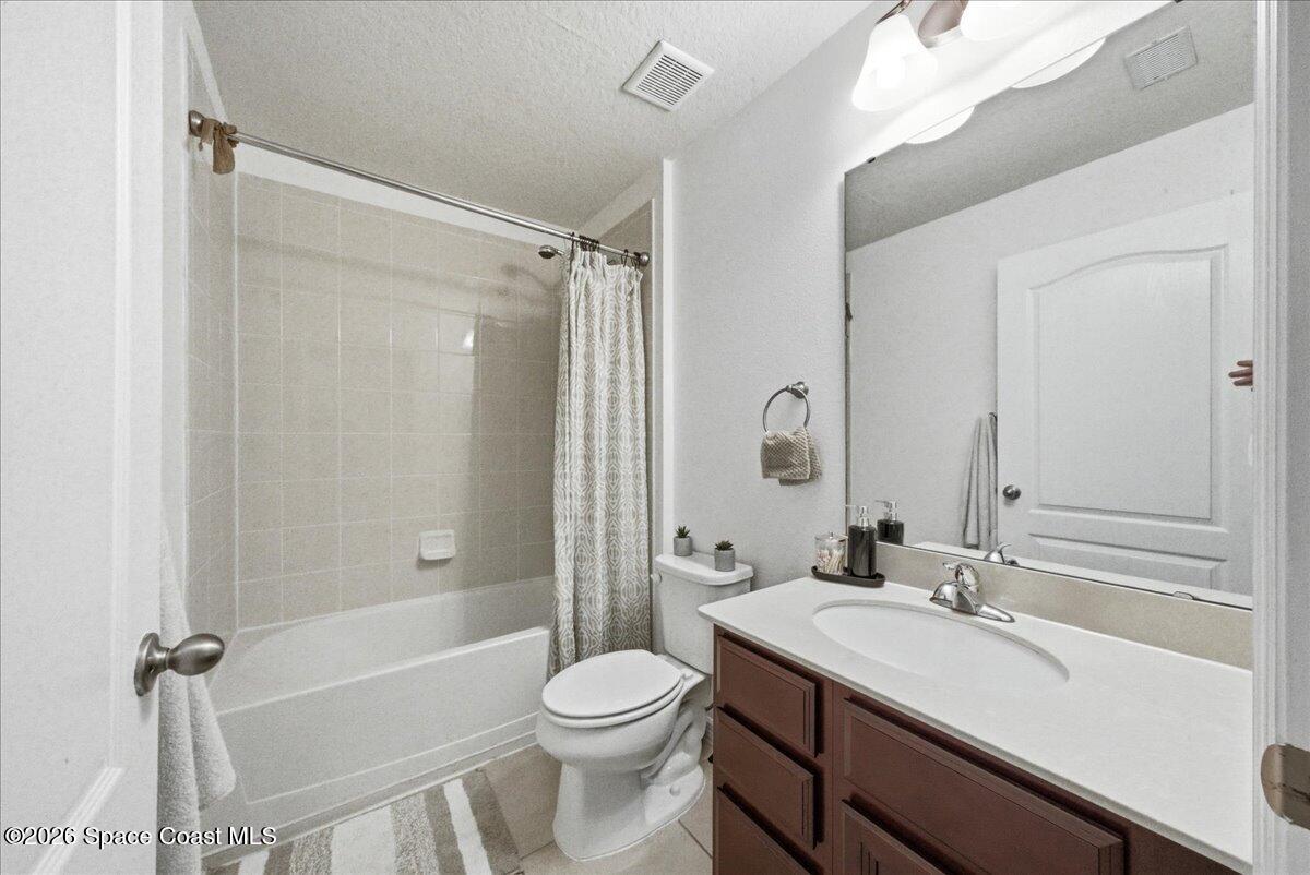 3258 Olivera Way St. Cloud, FL 34772 - Photo 23 of 30 a bathroom with a sink a toilet and shower