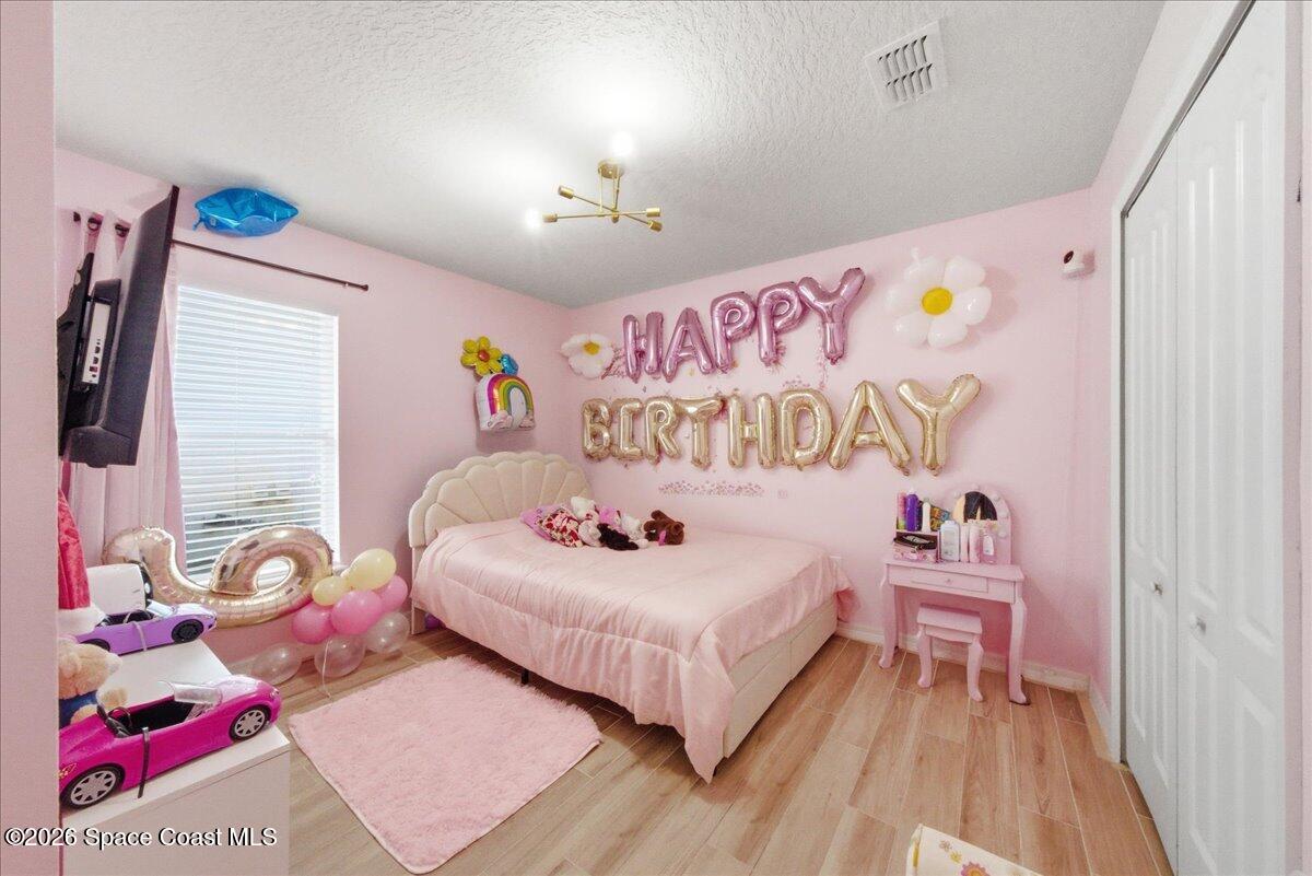 3258 Olivera Way St. Cloud, FL 34772 - Photo 24 of 30 a bedroom with a bed and a dresser