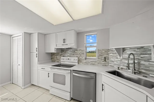 a kitchen with a sink stove and cabinets