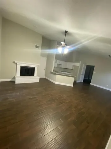 a view of kitchen and empty room