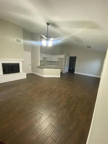 a view of an empty room with a fireplace