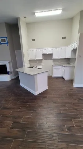 a living room with kitchen island granite countertop furniture and a fireplace
