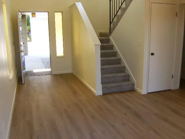 a view of an entryway with wooden floor