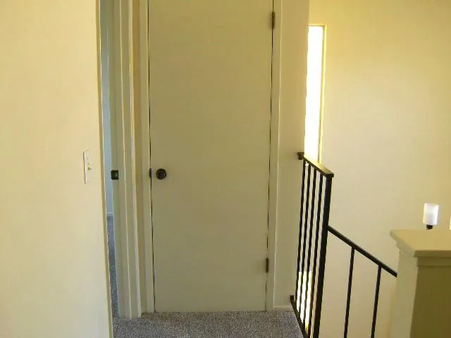 a view of a hallway with a door