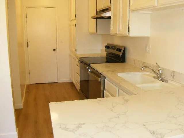 a kitchen with a sink and cabinets