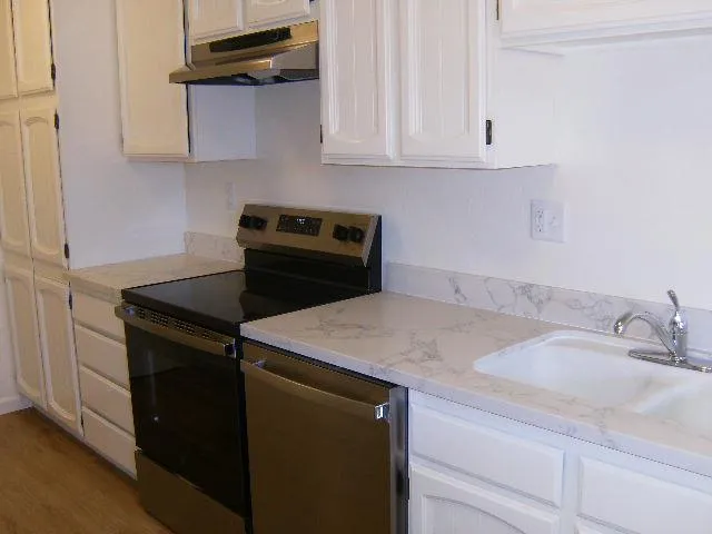 a kitchen with a sink and cabinets