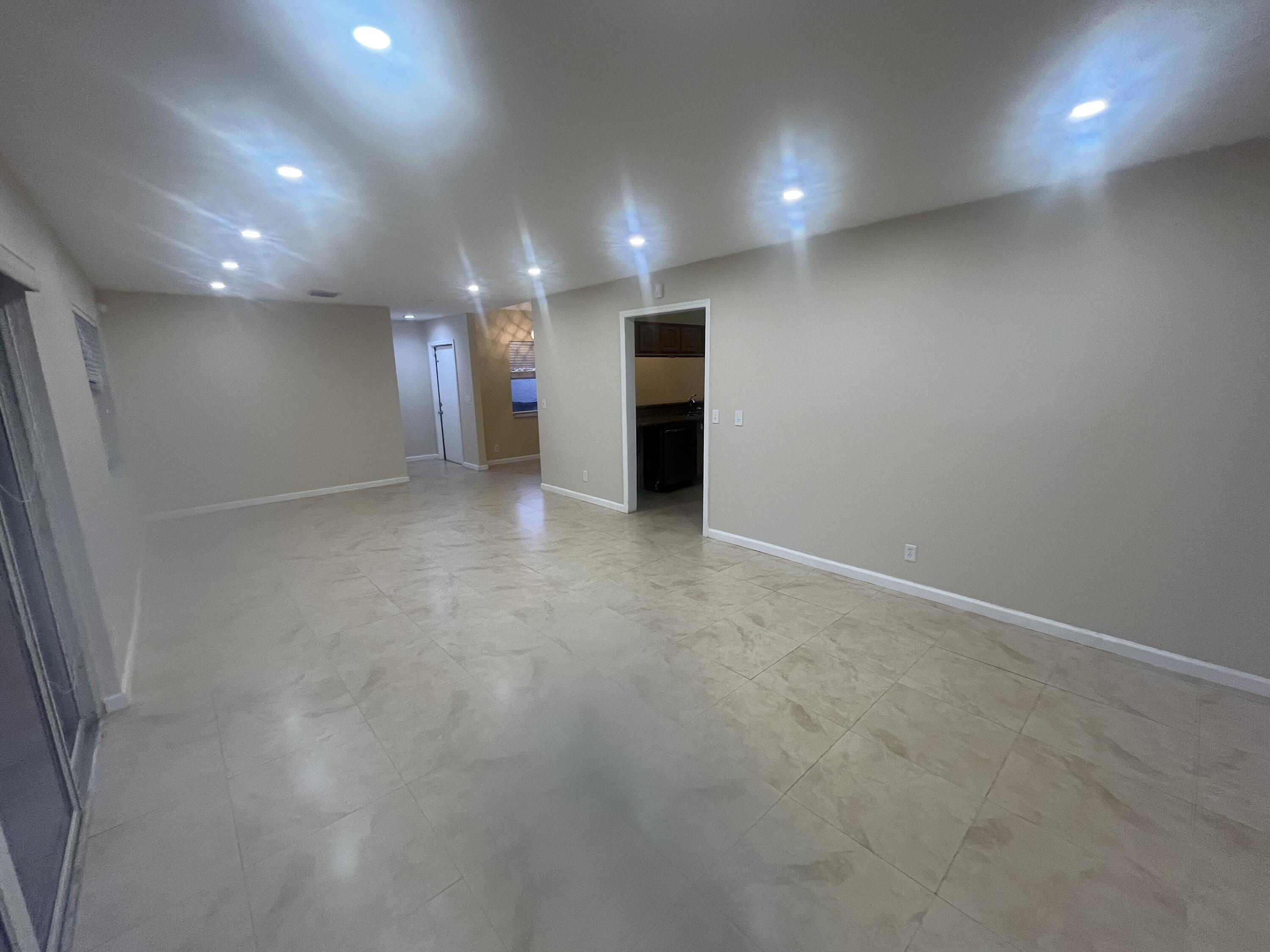 7420 Champagne Place Boca Raton, FL 33433 - Photo 13 of 32 an empty room with a hallway