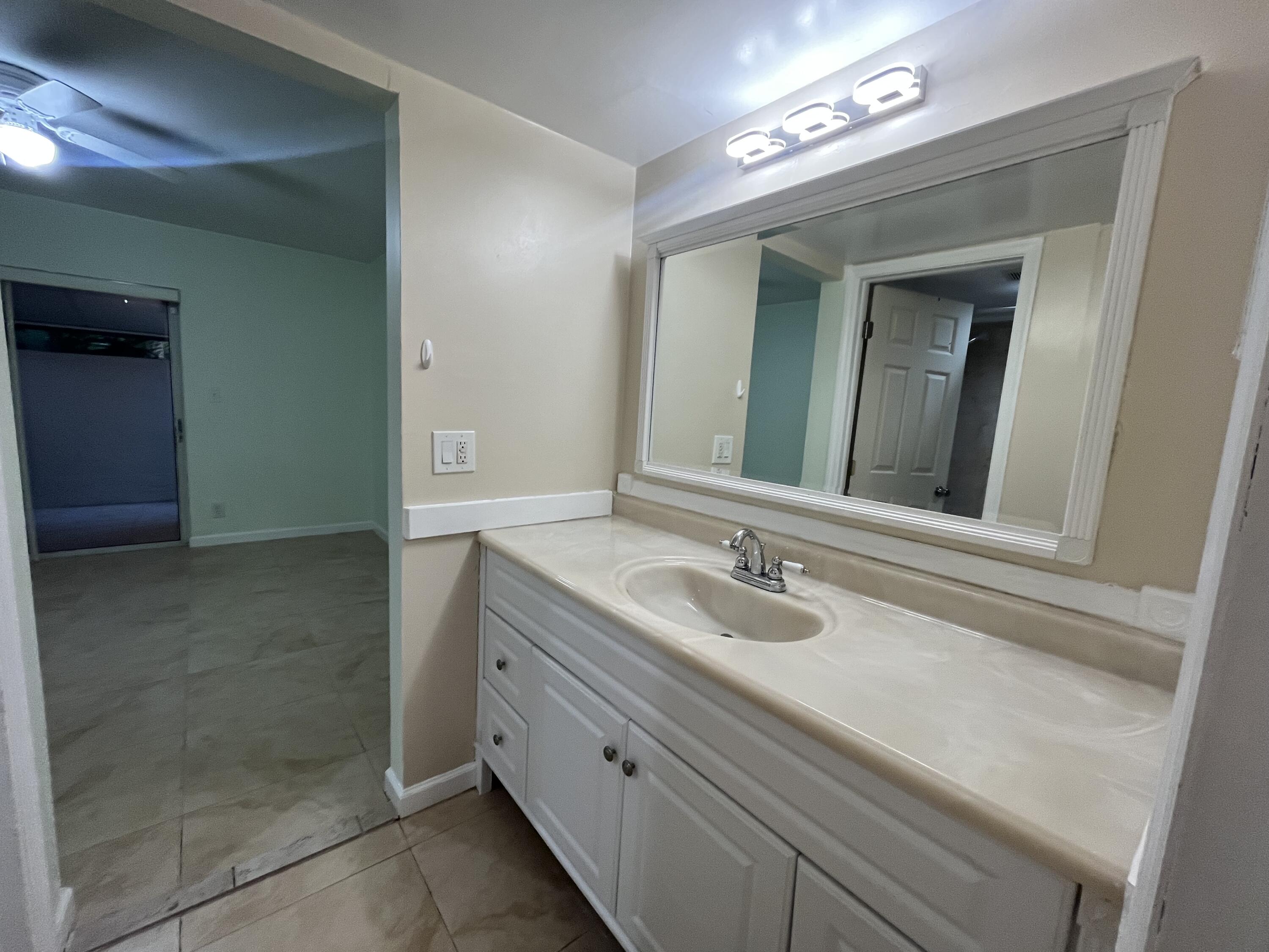 7420 Champagne Place Boca Raton, FL 33433 - Photo 20 of 32 a bathroom with a granite countertop sink and a mirror