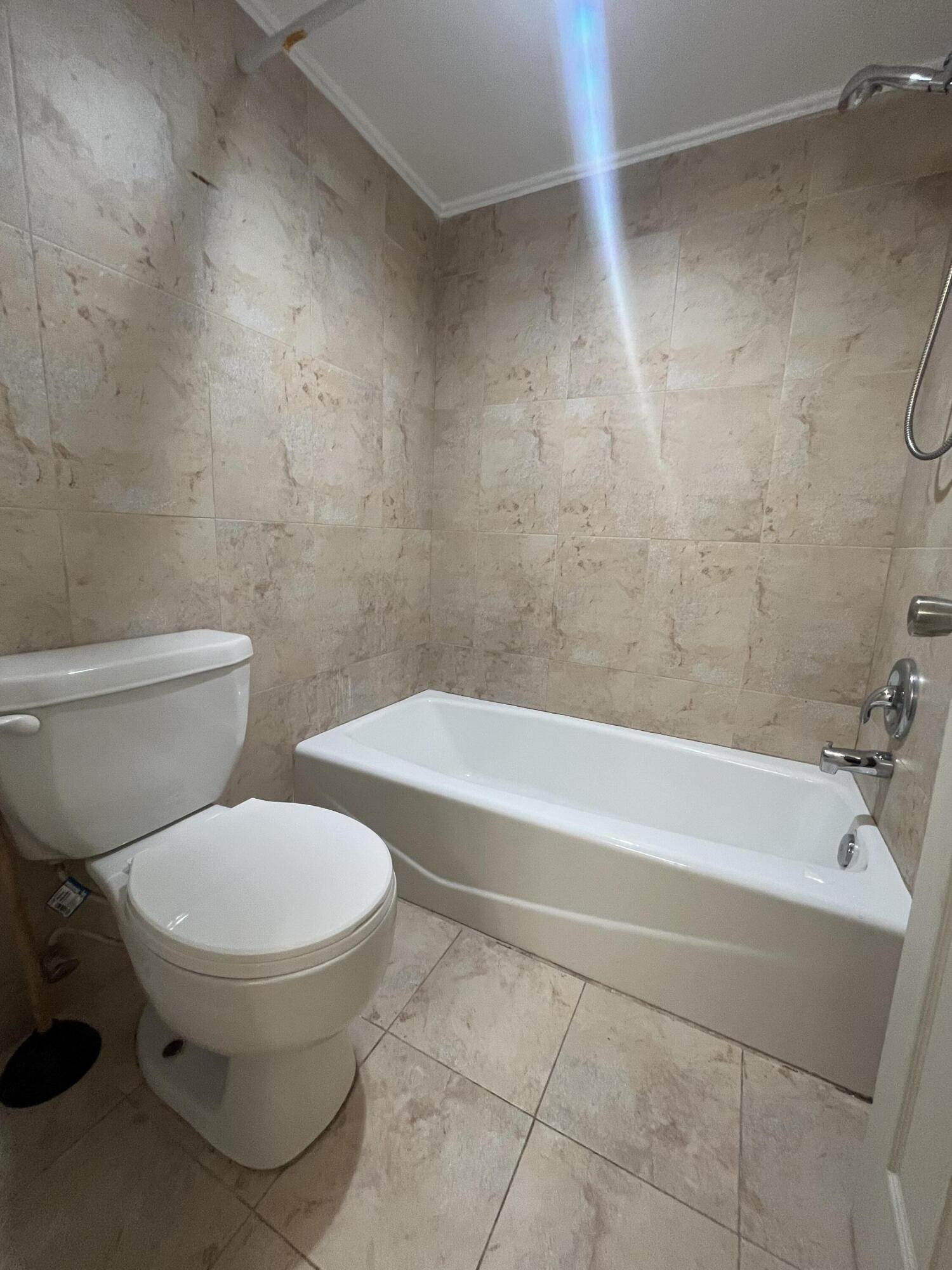 7420 Champagne Place Boca Raton, FL 33433 - Photo 21 of 32 a bathroom with a toilet and a bathtub