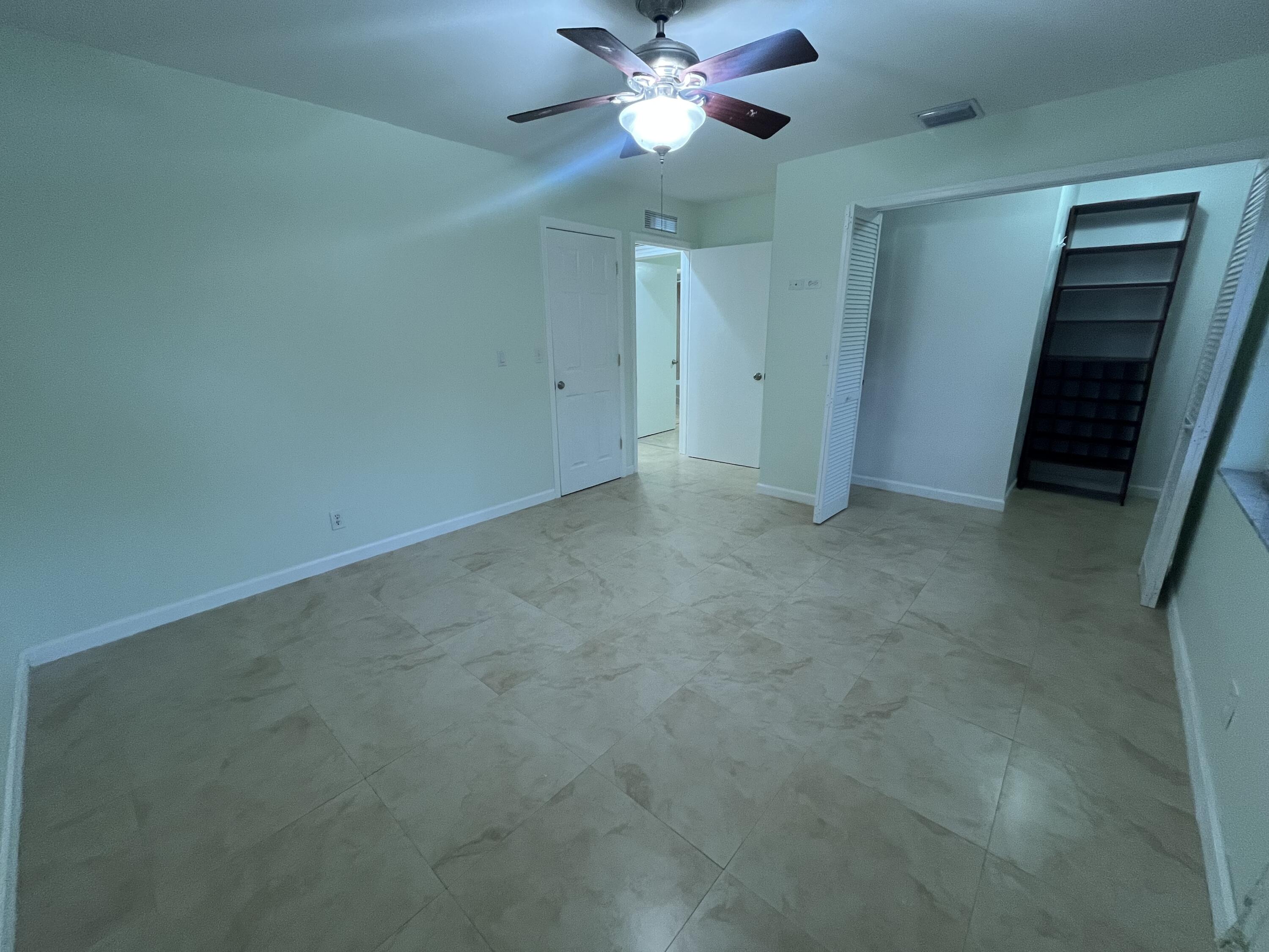 7420 Champagne Place Boca Raton, FL 33433 - Photo 25 of 32 an empty room with closet and a chandelier fan