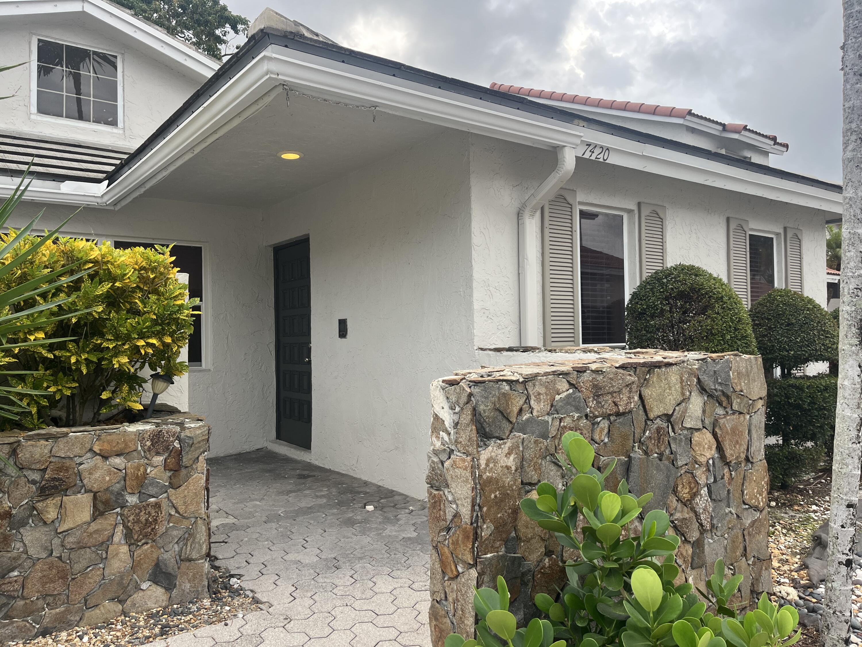 7420 Champagne Place Boca Raton, FL 33433 - Photo 3 of 32 a front view of a house