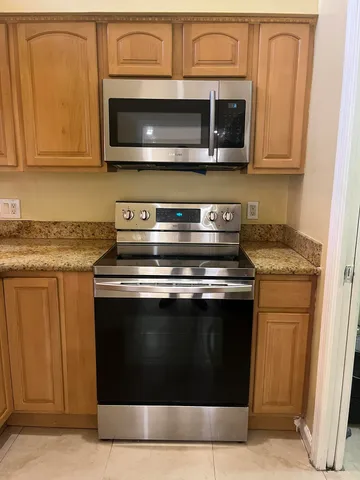 a stove top oven sitting inside of a kitchen