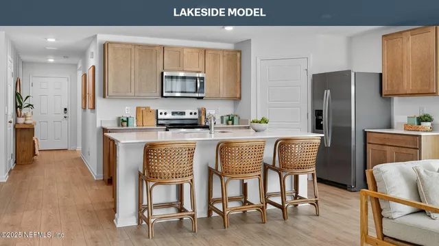 a living room with lots of furniture and kitchen view