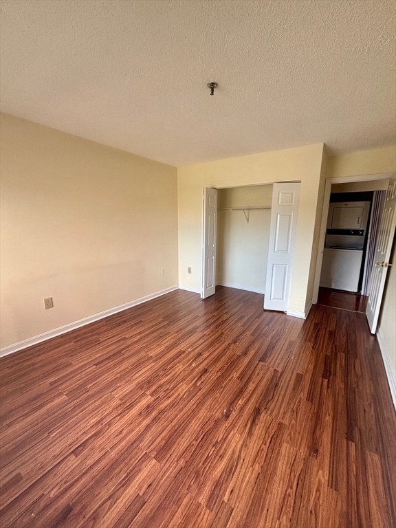 3920 Mystic Valley Parkway, Unit 115 Medford, MA 02155 - Photo 11 of 27 a view of a room with wooden floor and staircase