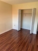 3920 Mystic Valley Parkway, Unit 115 Medford, MA 02155 - Photo 12 of 27 an empty room with wooden floor and closet