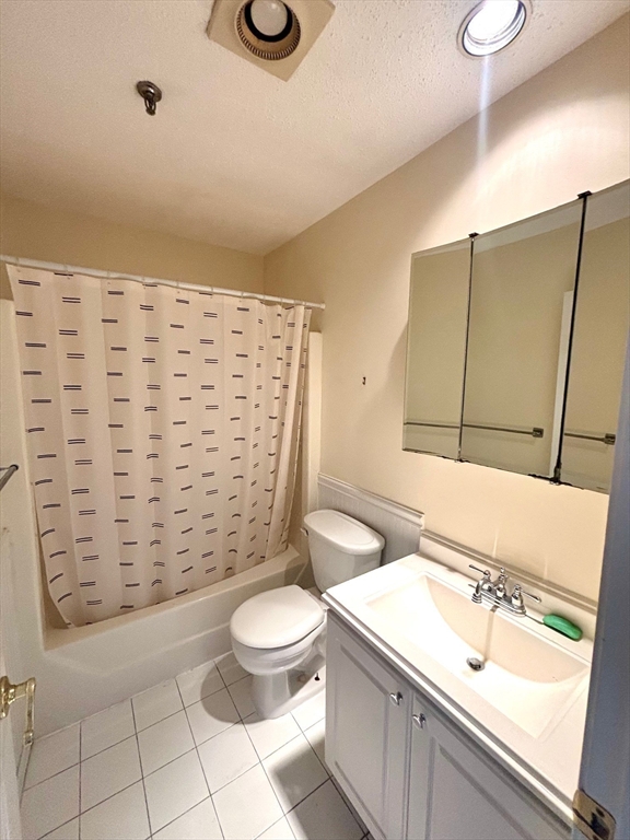 3920 Mystic Valley Parkway, Unit 115 Medford, MA 02155 - Photo 17 of 27 a bathroom with a sink a toilet and shower