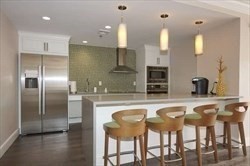 3920 Mystic Valley Parkway, Unit 115 Medford, MA 02155 - Photo 24 of 27 a kitchen with a table and chairs in it