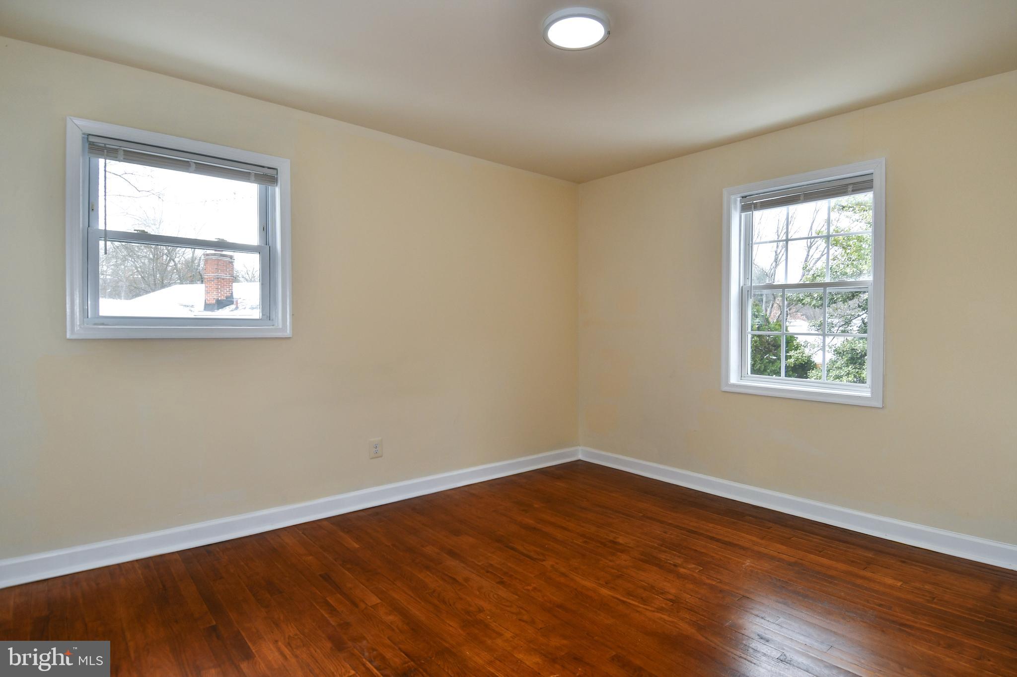 10304 Inwood Avenue Silver Spring, MD 20902 - Photo 11 of 24 a view of an empty room with wooden floor and a window