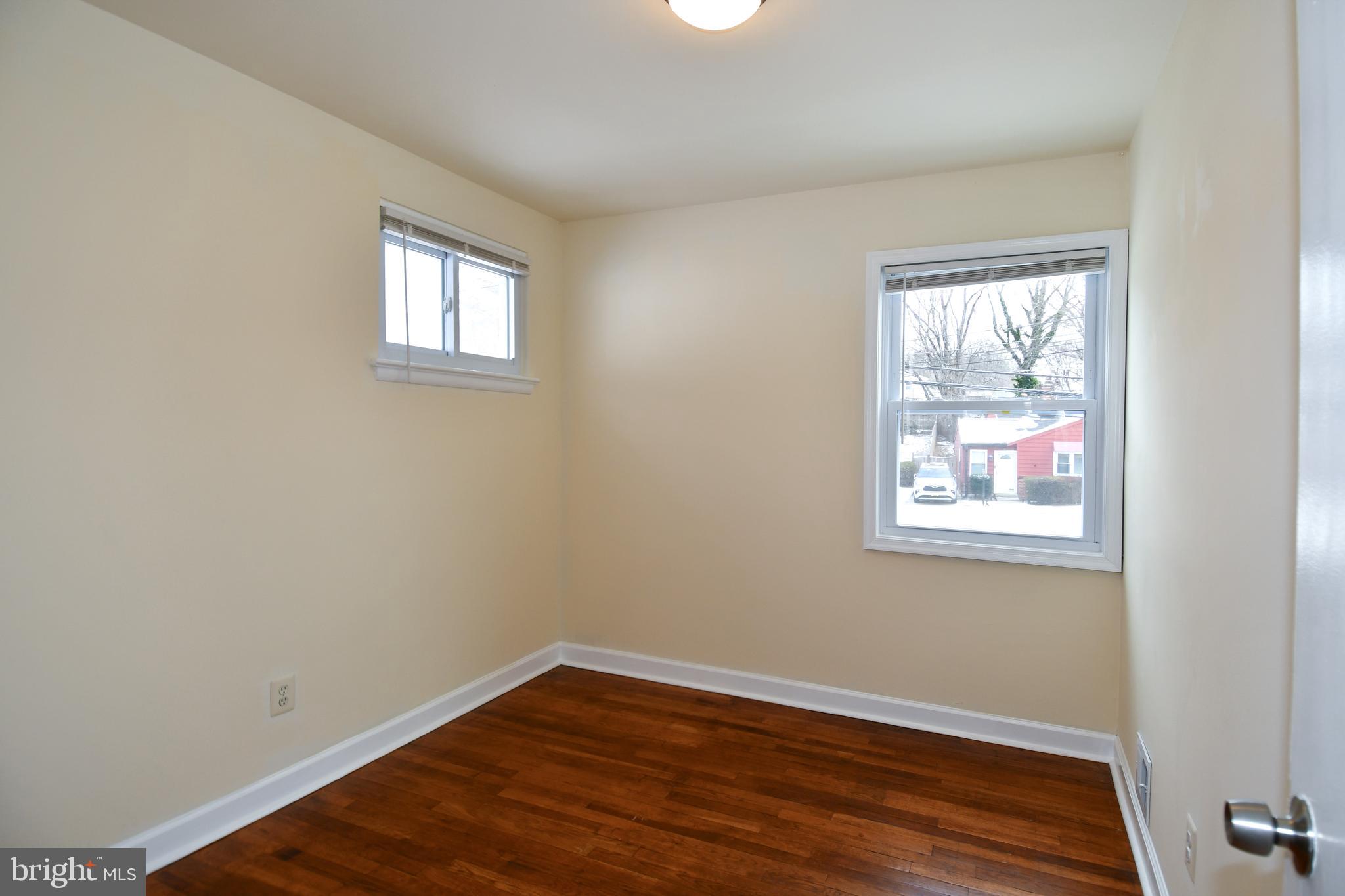 10304 Inwood Avenue Silver Spring, MD 20902 - Photo 12 of 24 a view of an empty room with wooden floor and a window