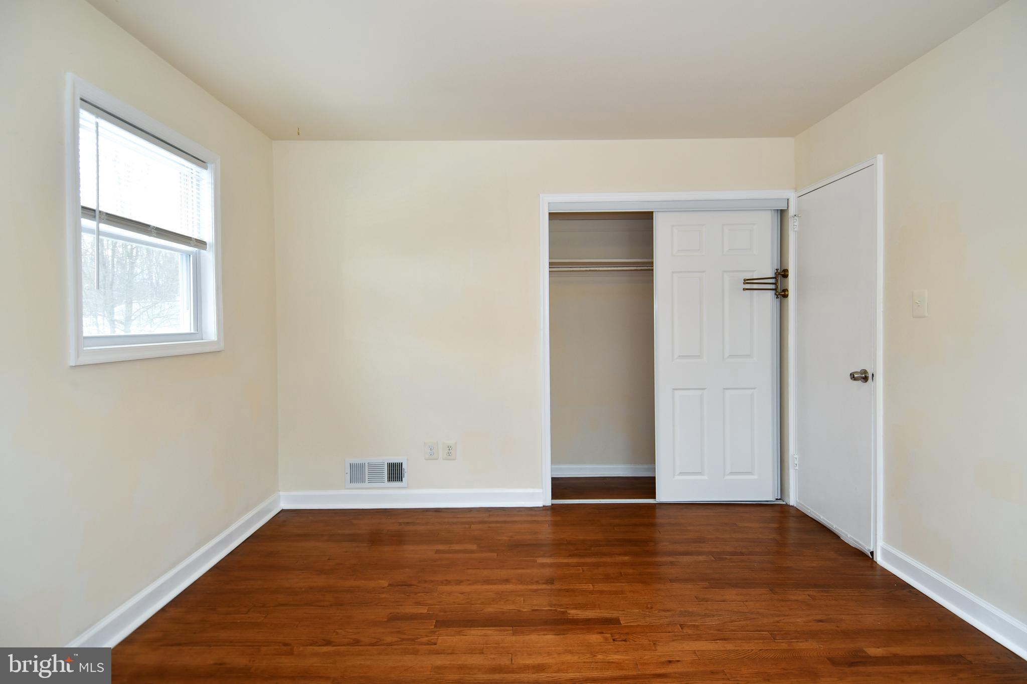 10304 Inwood Avenue Silver Spring, MD 20902 - Photo 14 of 24 an empty room with wooden floor and windows