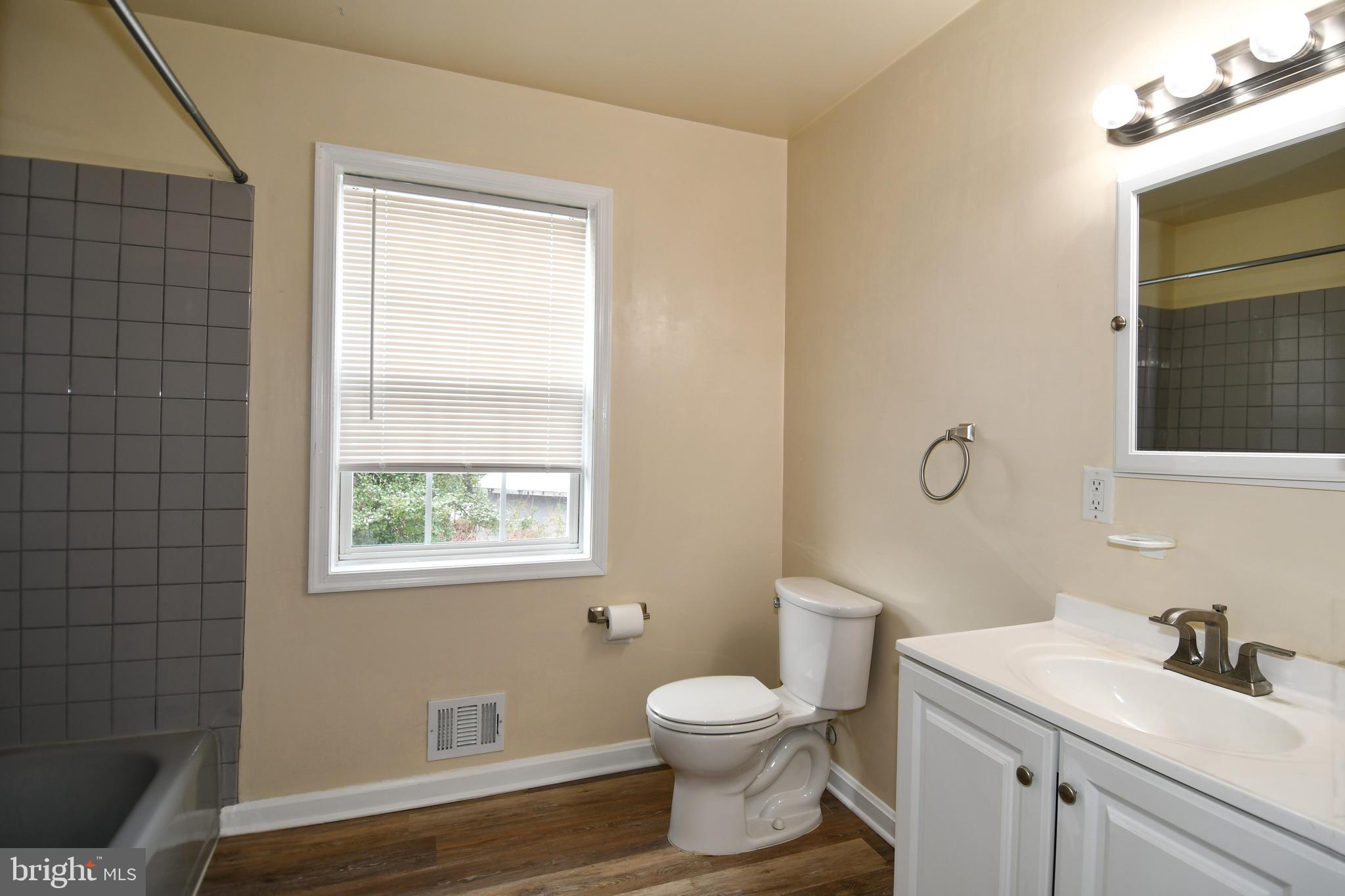 10304 Inwood Avenue Silver Spring, MD 20902 - Photo 16 of 24 a bathroom with a toilet sink vanity and mirror