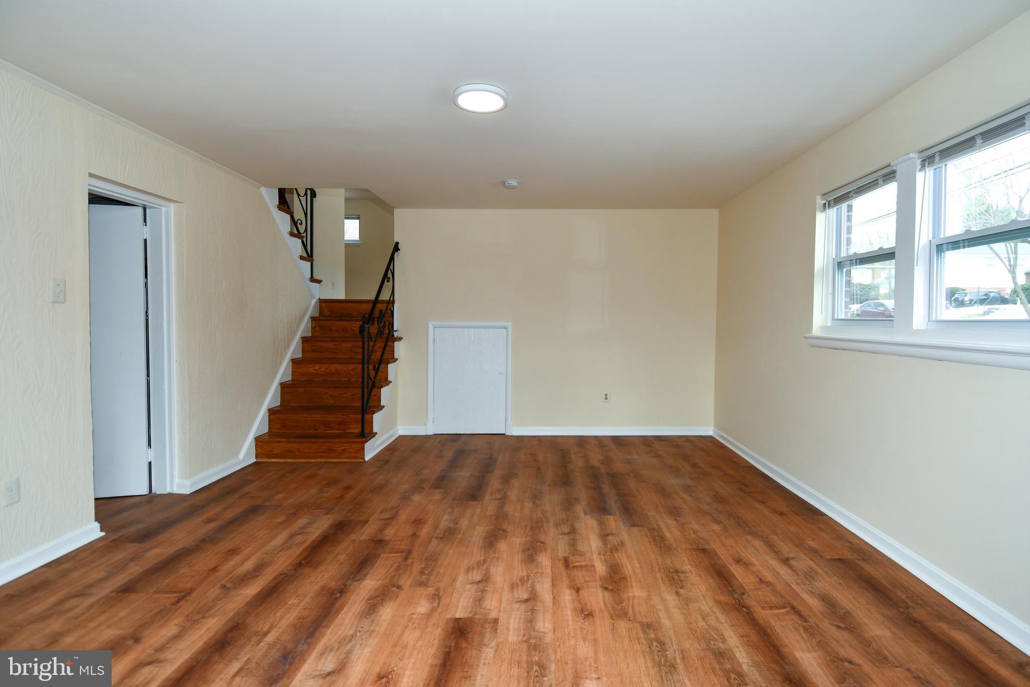 10304 Inwood Avenue Silver Spring, MD 20902 - Photo 17 of 24 a view of a room with wooden floor and stairs