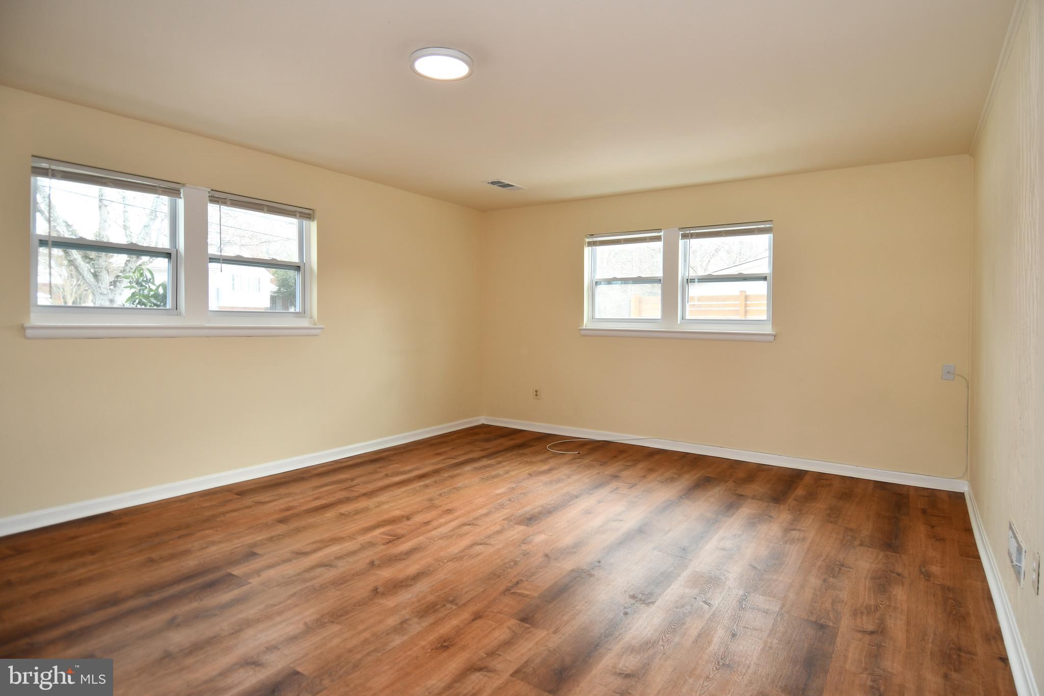 10304 Inwood Avenue Silver Spring, MD 20902 - Photo 18 of 24 an empty room with wooden floor and windows