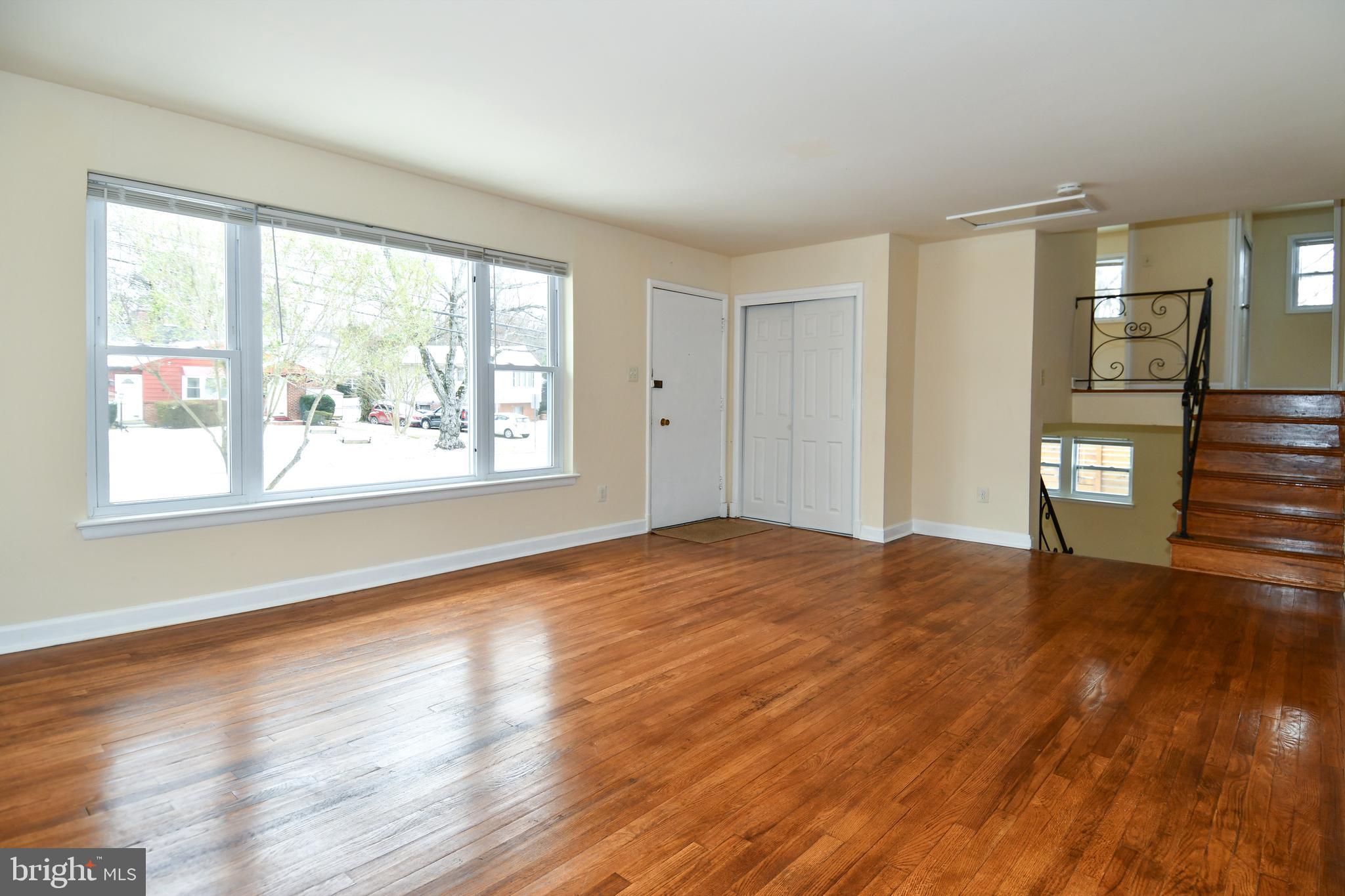 10304 Inwood Avenue Silver Spring, MD 20902 - Photo 3 of 24 a view of empty room with wooden floor and fan
