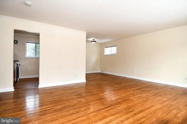 a view of an empty room and wooden floor