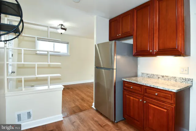 a kitchen with wooden cabinets and a refrigerator