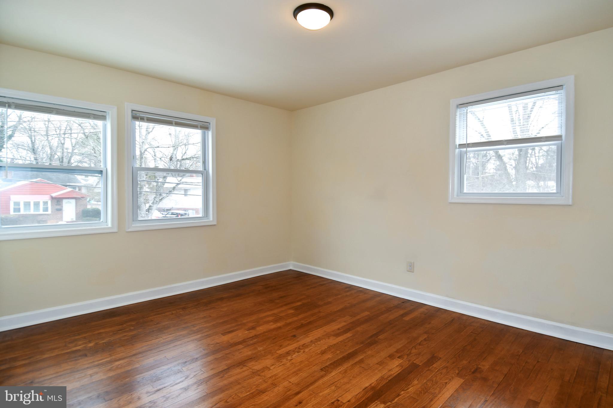 10304 Inwood Avenue Silver Spring, MD 20902 - Photo 9 of 24 a view of a room with wooden floor and windows