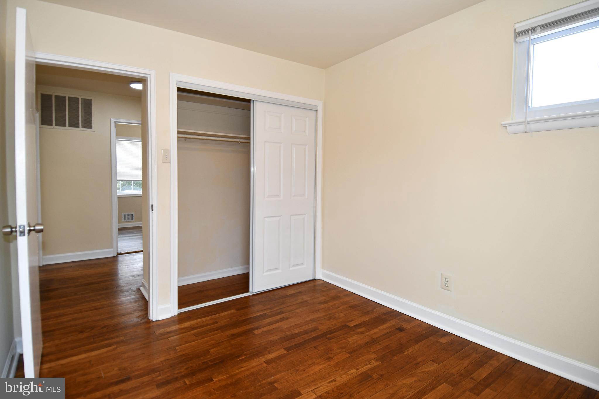 10304 Inwood Avenue Silver Spring, MD 20902 - Photo 10 of 24 an empty room with wooden floor & closet area