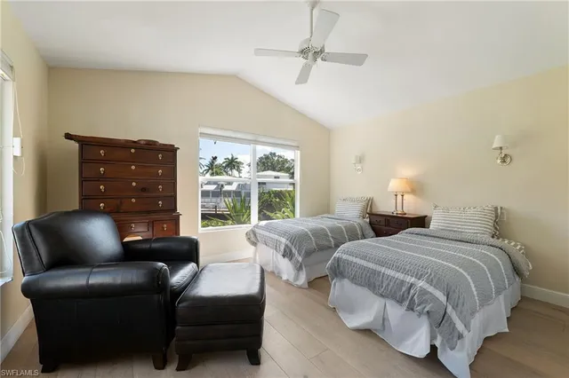 a bedroom with two beds and a couch