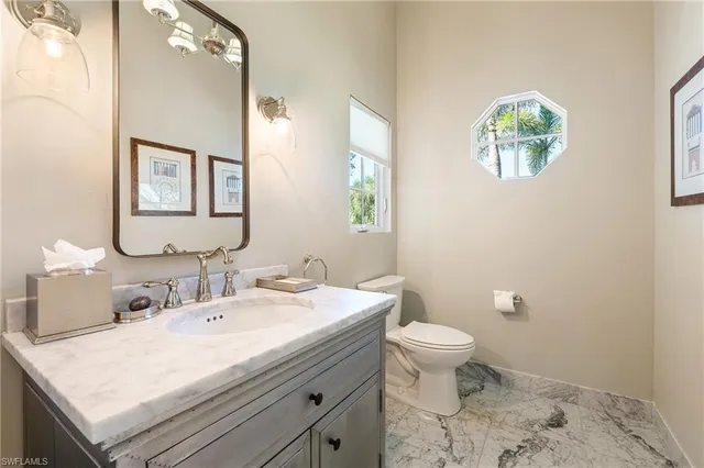 a bathroom with a sink toilet and a mirror