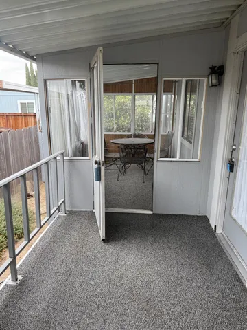 a view of a room with a window and furniture