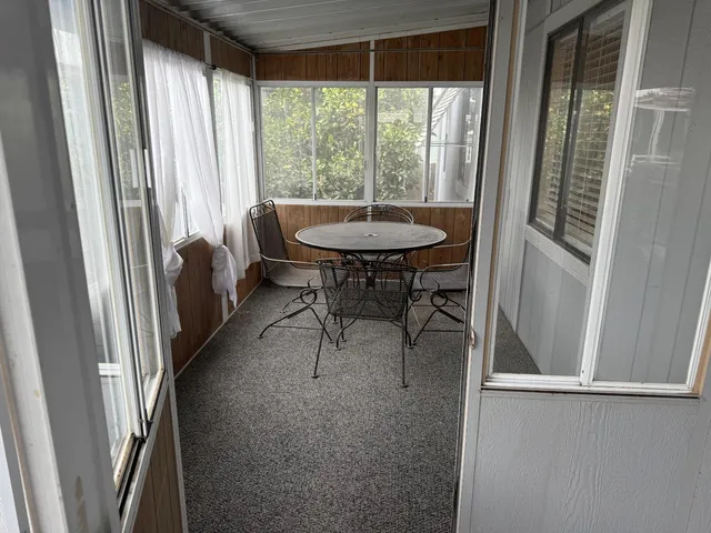 a kitchen with stainless steel appliances granite countertop a refrigerator a stove a sink and a window