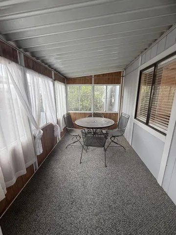 a kitchen with granite countertop a refrigerator and a stove top oven