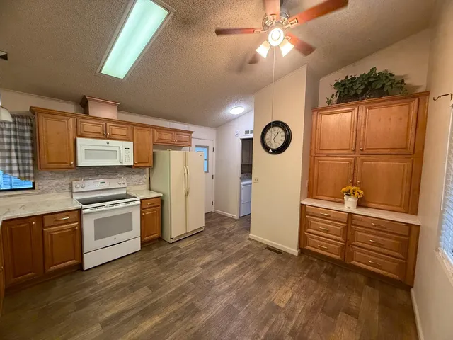 a kitchen with a stove top oven and refrigerator