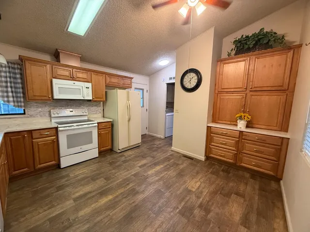 a large kitchen with a stove a refrigerator and a sink