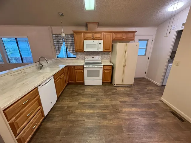 a view of a room with wooden floor
