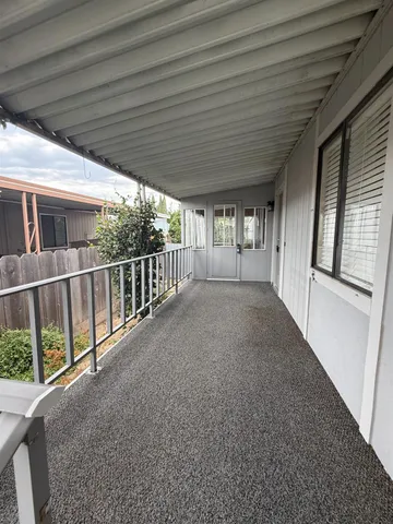 a view of a porch with wooden floor