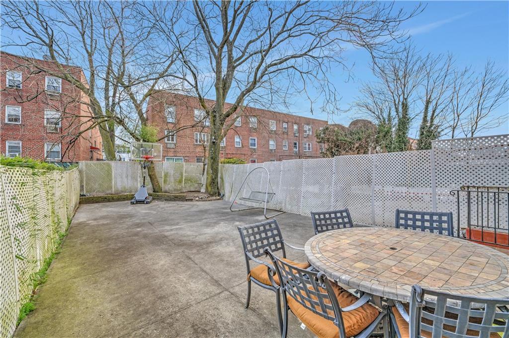 1262 East 73rd Street Brooklyn, NY 11234 - Photo 12 of 26 a backyard of a house with table and chairs